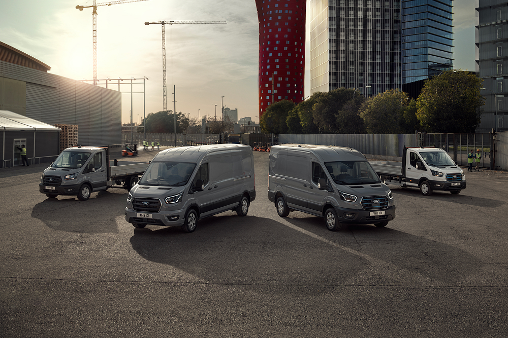 The range of Ford electric and plug-in hybrid vans parked outside in a carpark.