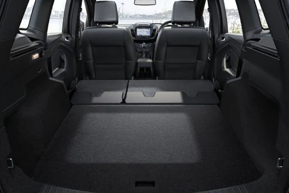 The empty trunk space of a Ford vehicle.