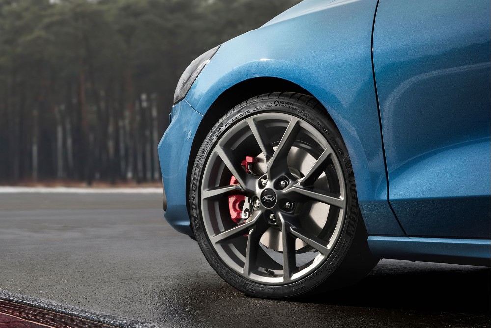 Close-up of the wheel and tire of a blue Ford Fiesta ST.