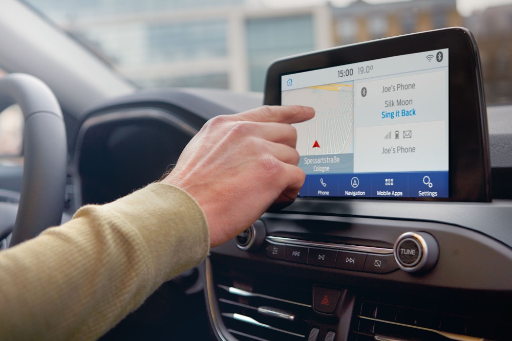 Person using Ford SYNC inside a car
