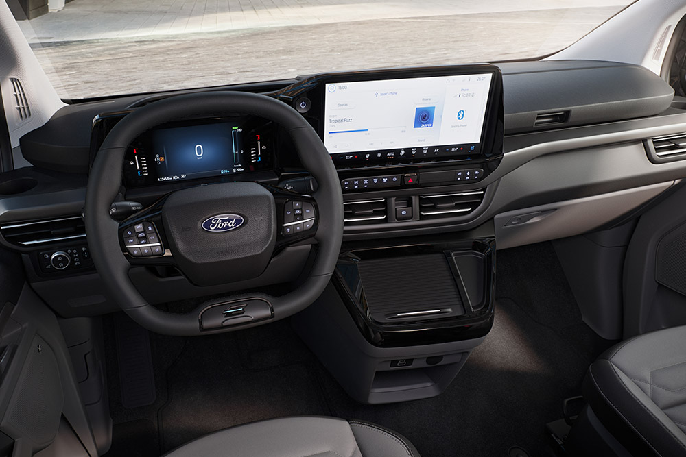 The interior dashboard and steering wheel of the Ford Tourneo Custom.