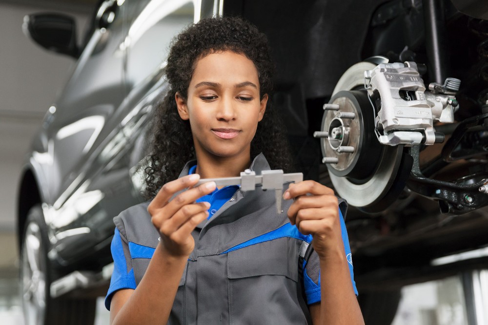 Ford technician holding vernier caliper measuring tool