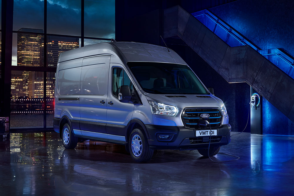 E-Transit parked in showroom with blue lights at background