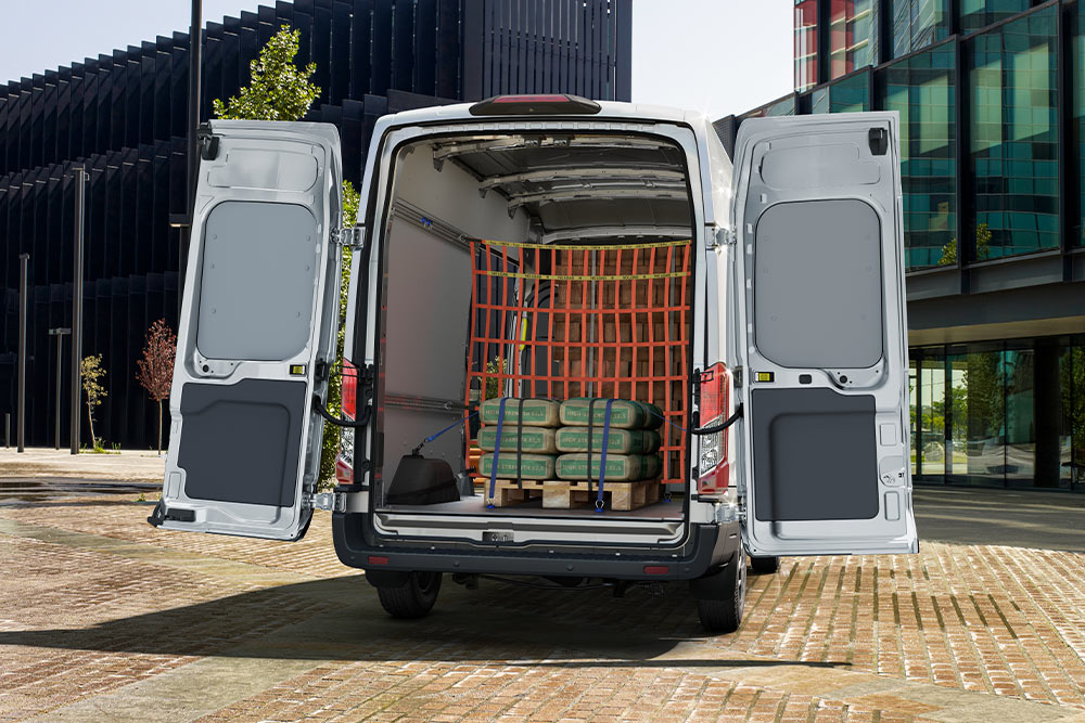 Ford Transit Double Cab with open rear doors, cargo inside.