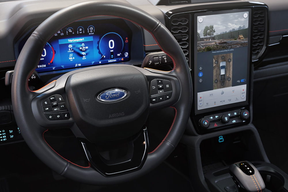 Ford Ranger's steering wheel, digital instrument cluster, and infotainment screen.