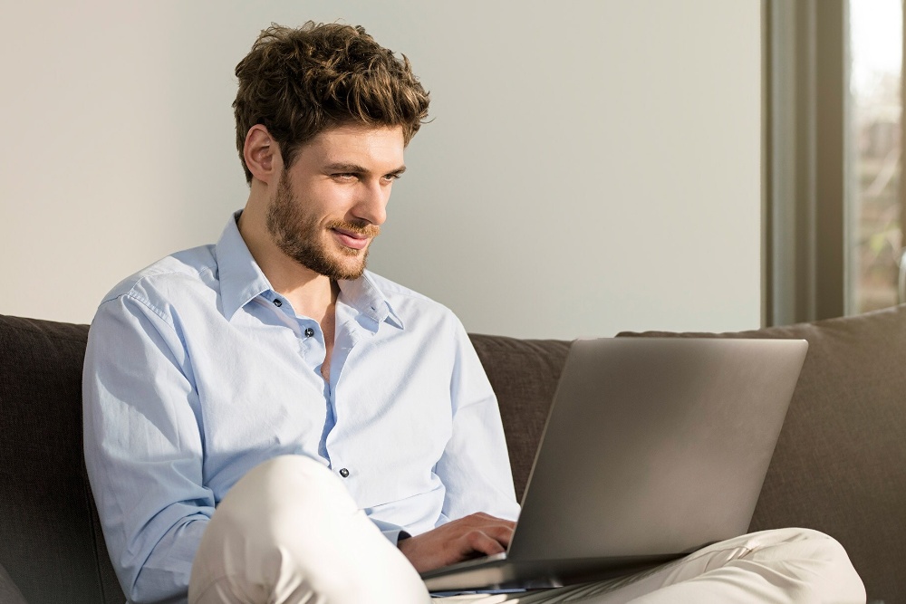  Man on laptop, using Ford's online service booking feature