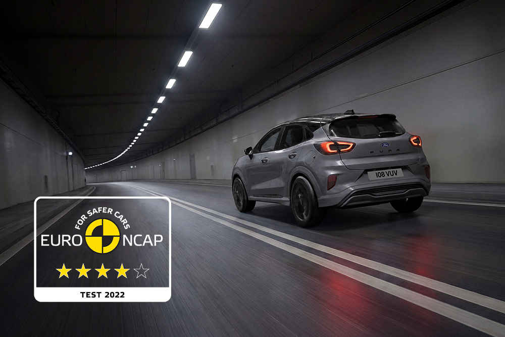 Grey Ford Puma driving through a concrete tunnel, next to an Euro NCAP logo.