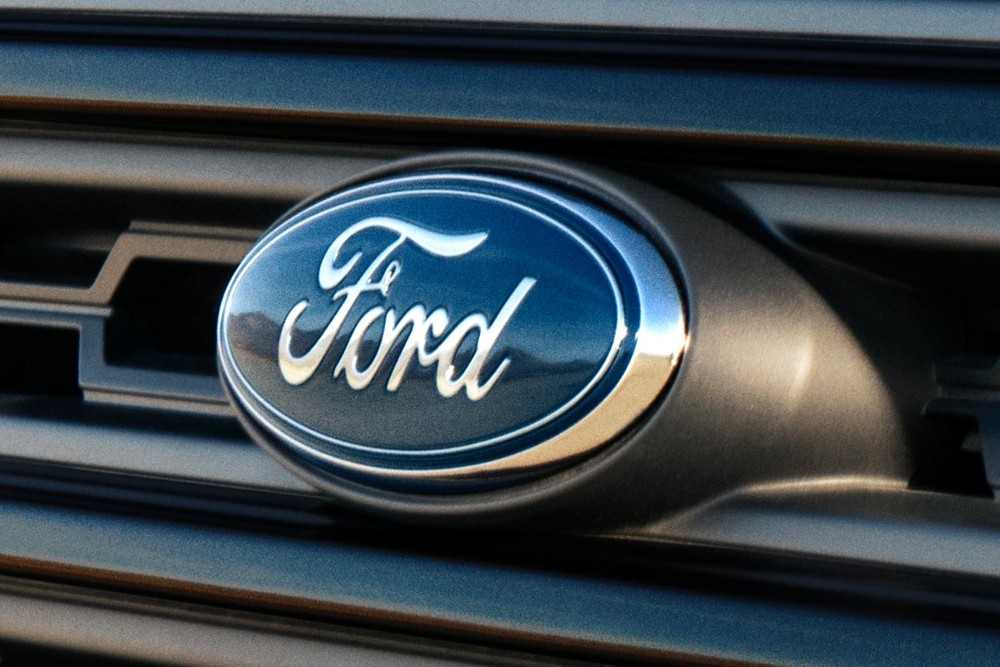 Close-up of the Ford logo badge on a dark vehicle grille.