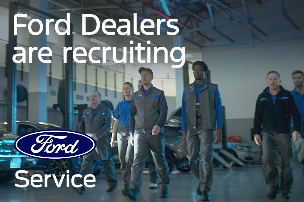  Ford technicians walk towards the camera in a dealership garage. The tex "Ford Dealers are recruiting" and the Ford logo are displayed.