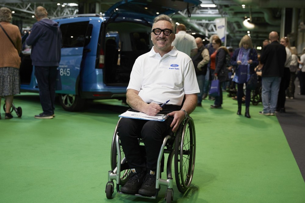 Smiling Ford event organiser sitting in a wheelchair